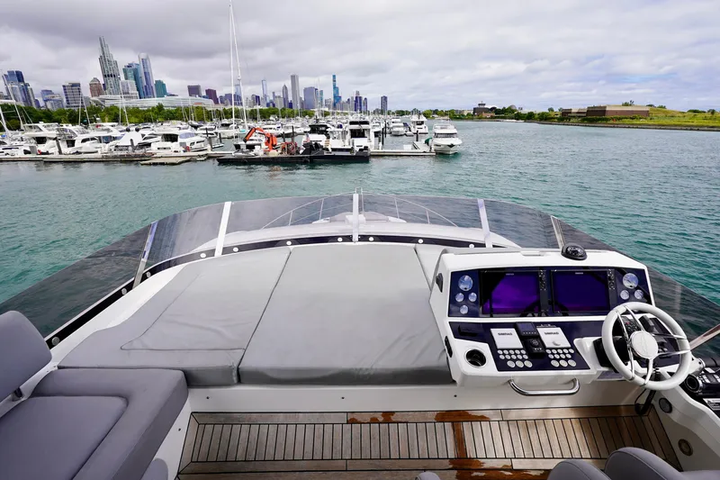  Yacht Photos Pics 2019 Sunseeker Manhattan 66 yacht helm with city skyline and marina view.