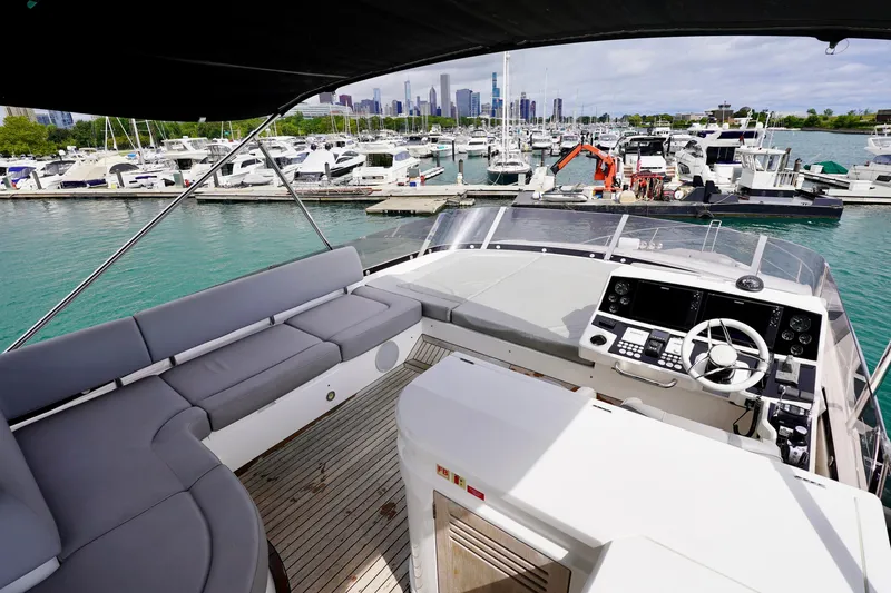  Yacht Photos Pics Luxurious 2019 Sunseeker Manhattan 66 yacht interior at marina, featuring modern helm and seating.