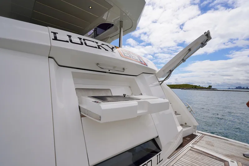  Yacht Photos Pics 2019 Sunseeker Manhattan 66 yacht with outdoor grill, docked by the water.