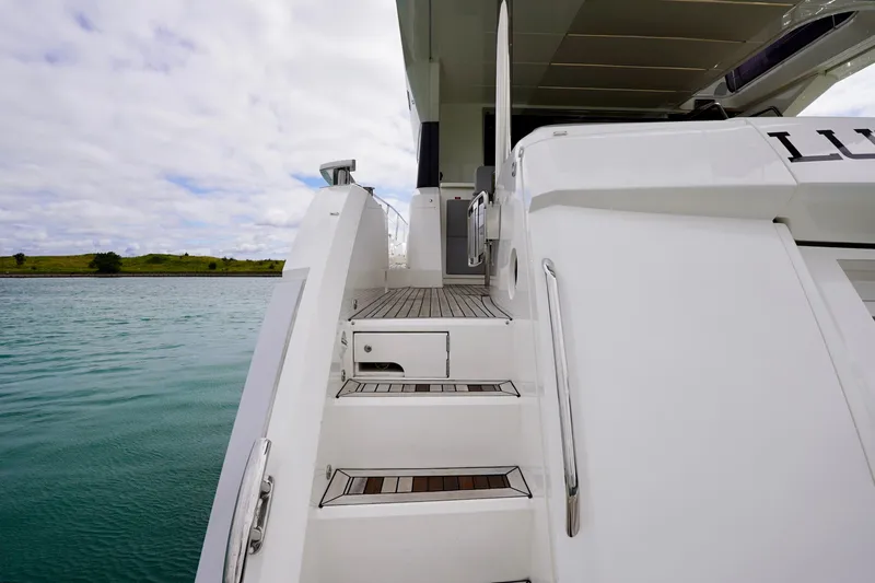  Yacht Photos Pics Sunseeker Manhattan 66 yacht, 2019 model, featuring elegant deck stairs and sleek design.