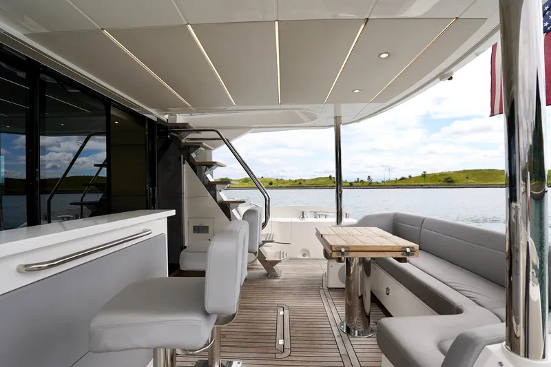  Yacht Photos Pics Luxurious 2019 Sunseeker Manhattan 66 yacht interior with seating, table, and water view.