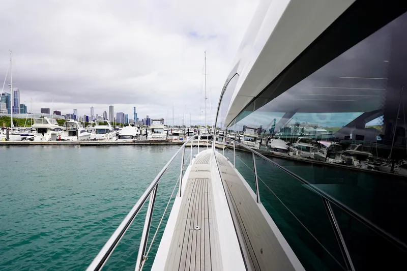  Yacht Photos Pics 2019 Sunseeker Manhattan 66 yacht docked in marina with city skyline view.