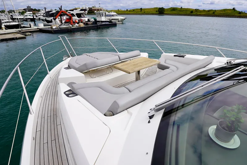  Yacht Photos Pics Luxurious 2019 Sunseeker Manhattan 66 yacht with elegant deck seating and table.