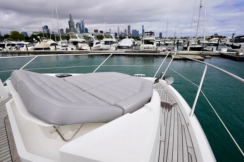  Yacht Photos Pics 2019 Sunseeker Manhattan 66 yacht docked in marina with city skyline in background.