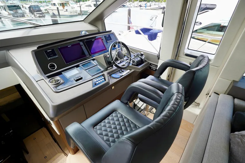  Yacht Photos Pics Luxurious helm station of 2019 Sunseeker Manhattan 66 yacht with modern controls and seating.