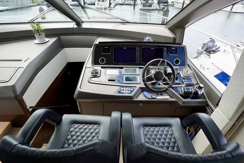  Yacht Photos Pics Cockpit of 2019 Sunseeker Manhattan 66 yacht with modern controls and leather seating.