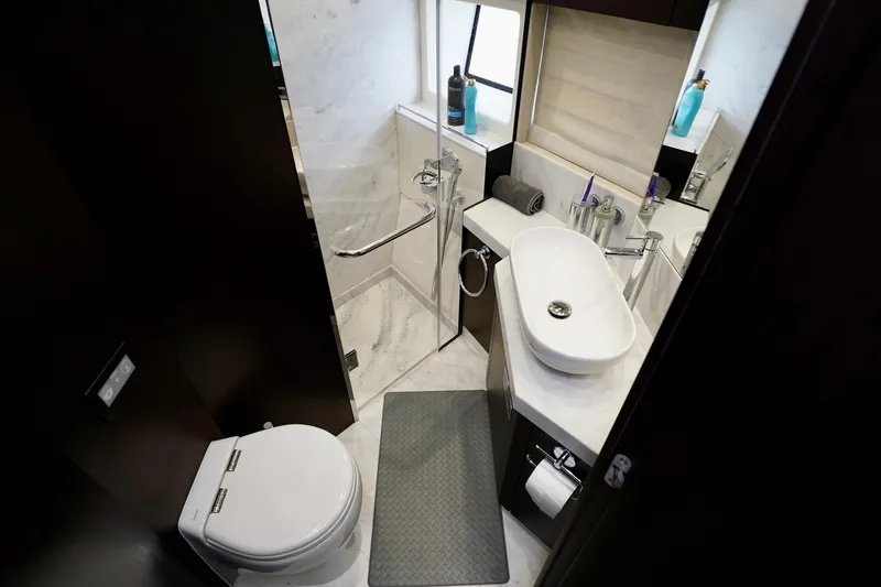  Yacht Photos Pics Luxurious bathroom in 2019 Sunseeker Manhattan 66 yacht, featuring modern fixtures and elegant design.