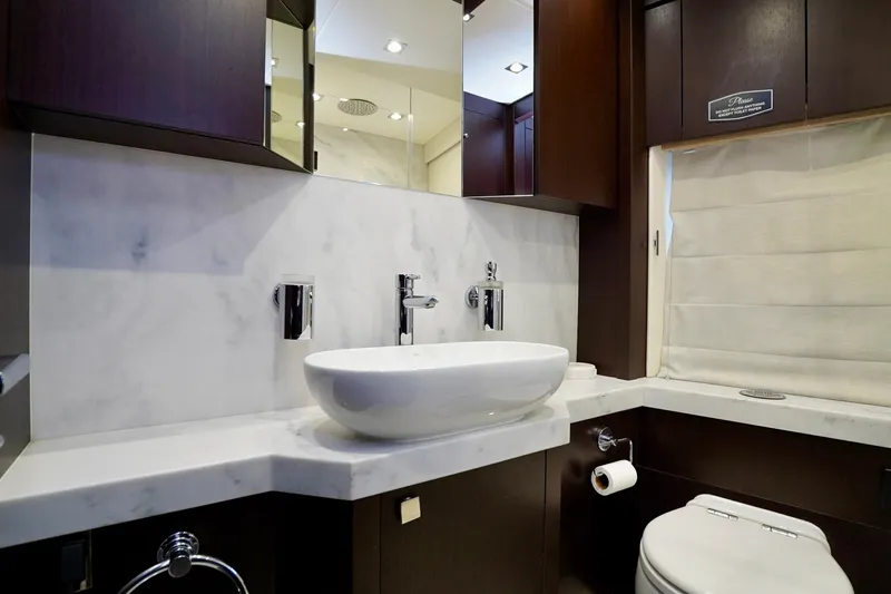  Yacht Photos Pics Luxurious bathroom in 2019 Sunseeker Manhattan 66 yacht with modern fixtures and marble accents.