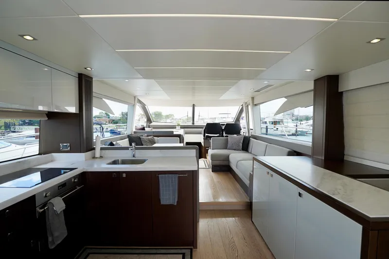  Yacht Photos Pics Luxurious interior of 2019 Sunseeker Manhattan 66 yacht with modern kitchen and seating area.