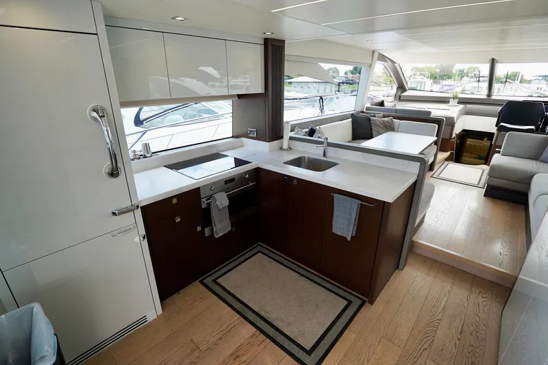  Yacht Photos Pics Luxurious interior of 2019 Sunseeker Manhattan 66 yacht with modern kitchen and seating area.
