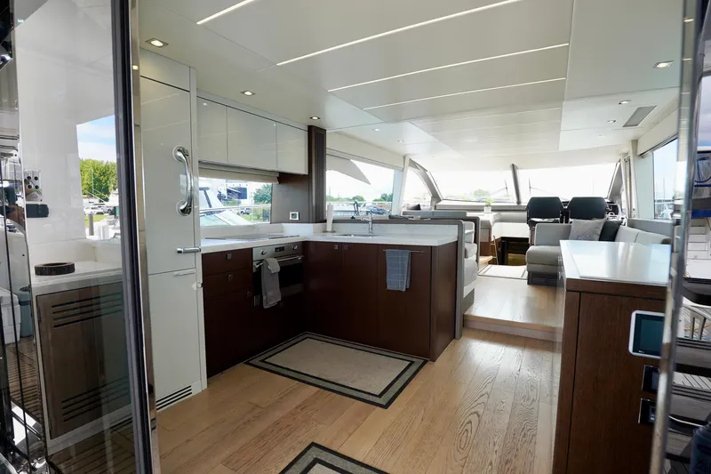 Yacht Photos Pics Luxurious interior of 2019 Sunseeker Manhattan 66 yacht with modern kitchen and seating area.