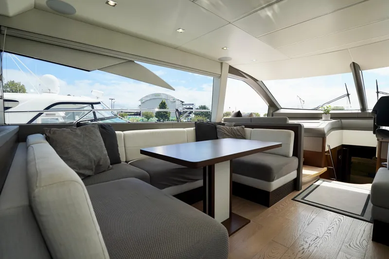  Yacht Photos Pics Luxurious interior of 2019 Sunseeker Manhattan 66 yacht with elegant seating and panoramic windows.