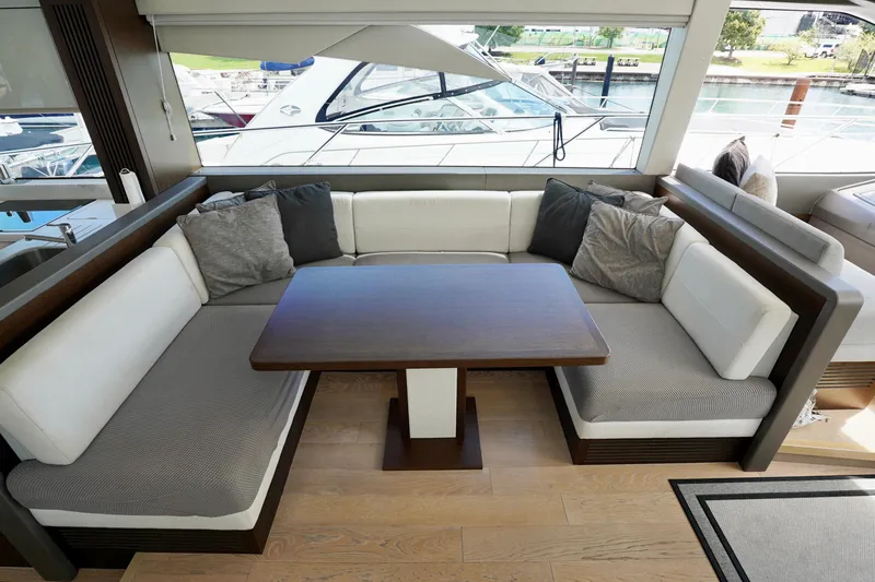  Yacht Photos Pics Luxurious interior of 2019 Sunseeker Manhattan 66 yacht with elegant seating and table.