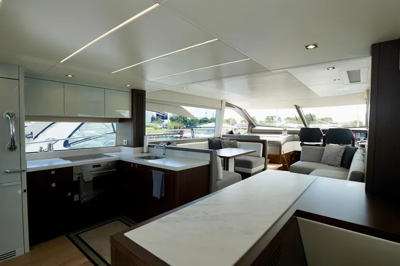  Yacht Photos Pics Luxurious interior of 2019 Sunseeker Manhattan 66 yacht with modern kitchen and seating area.