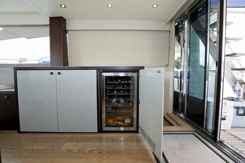 Yacht Photos Pics Luxurious interior of 2019 Sunseeker Manhattan 66 yacht with wine cooler and modern cabinetry.
