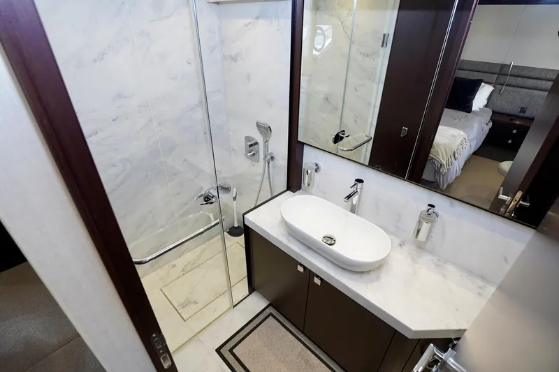  Yacht Photos Pics Luxurious bathroom in 2019 Sunseeker Manhattan 66 yacht with modern fixtures and elegant design.