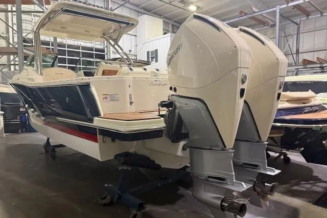  Yacht Photos Pics 2023 Chris-Craft Calypso 28 boat with dual outboard engines in a storage facility.