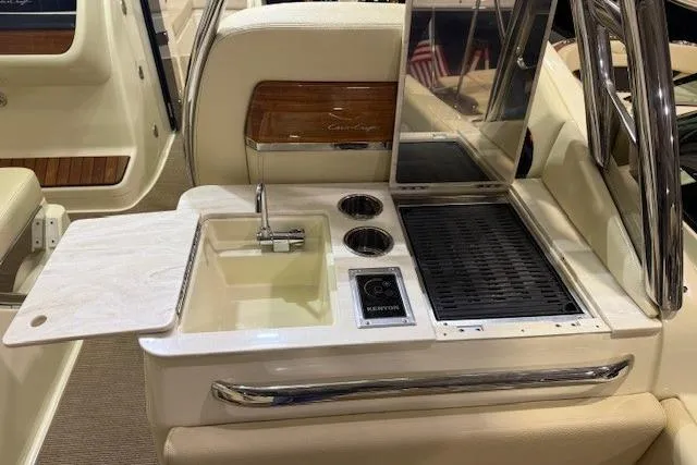  Yacht Photos Pics 2023 Chris-Craft Calypso 28 boat interior with sink, grill, and cup holders.