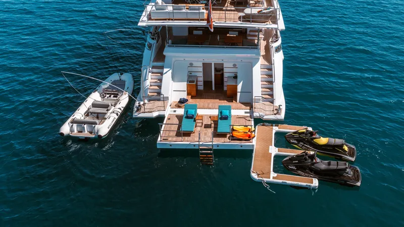 Exinity Yacht Photos Pics Luxury Benetti Fast 125 yacht with jet skis and tender, 2021 model, on open water.