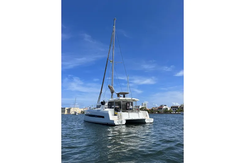 Oz Yacht Photos Pics 2019 Bali 4.1 catamaran sailing on calm waters under a clear blue sky.