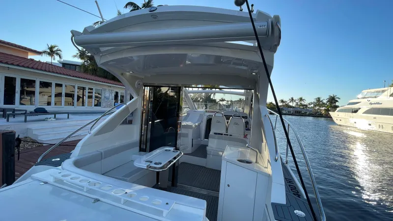  Yacht Photos Pics Evolve 400HT 2022 yacht docked by waterfront, showcasing sleek design and spacious deck.