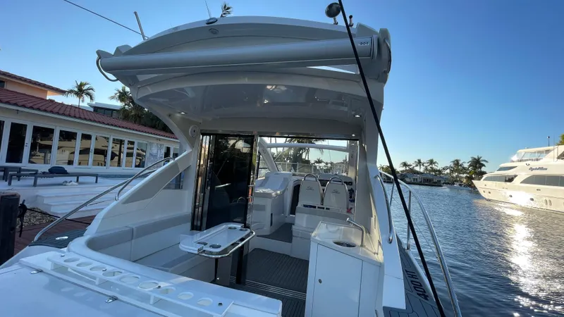  Yacht Photos Pics 2022 Evolve 400HT yacht docked by waterfront homes, sunny day.