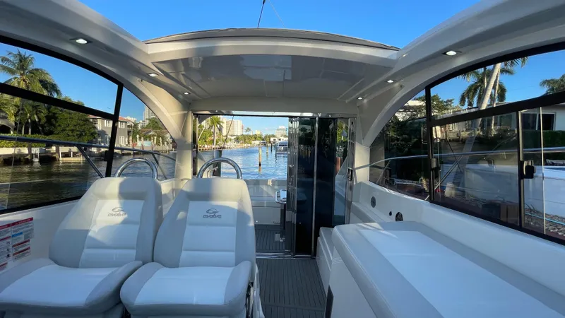  Yacht Photos Pics Interior view of 2022 Evolve 400HT yacht with luxurious seating and scenic waterway.