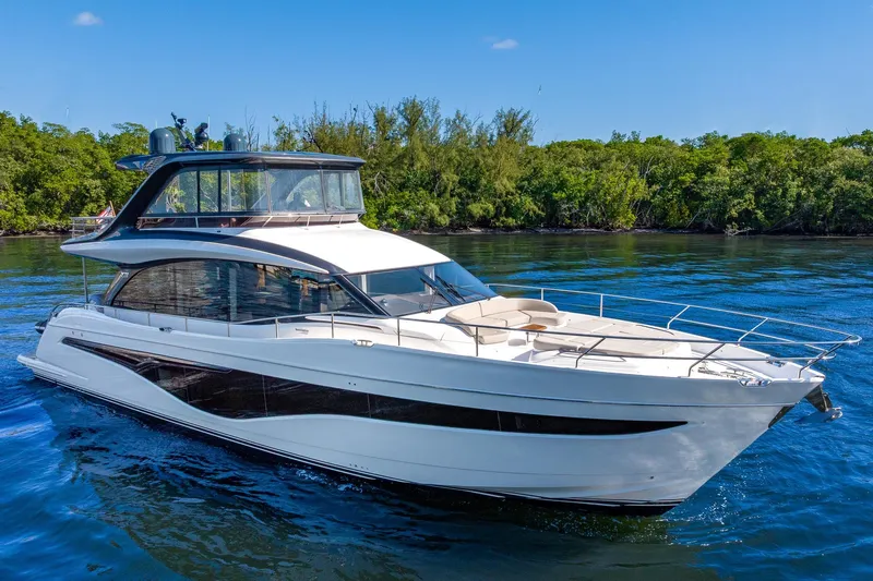 Her Way Yacht Photos Pics Luxurious 2023 Princess Y72 yacht cruising on serene waters, surrounded by lush greenery.