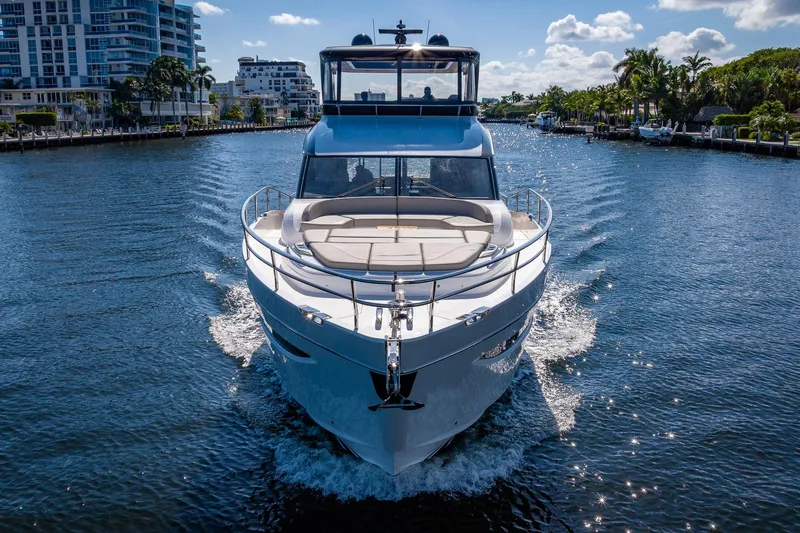 Her Way Yacht Photos Pics Luxurious 2023 Princess Y72 yacht cruising on a sunny day in a scenic waterway.