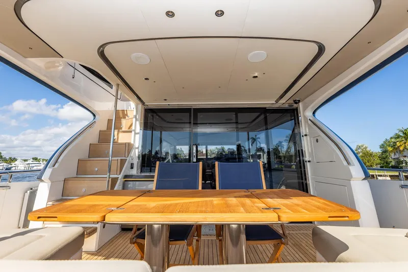 Her Way Yacht Photos Pics Luxurious 2023 Princess Y72 yacht interior with elegant wooden table and seating.
