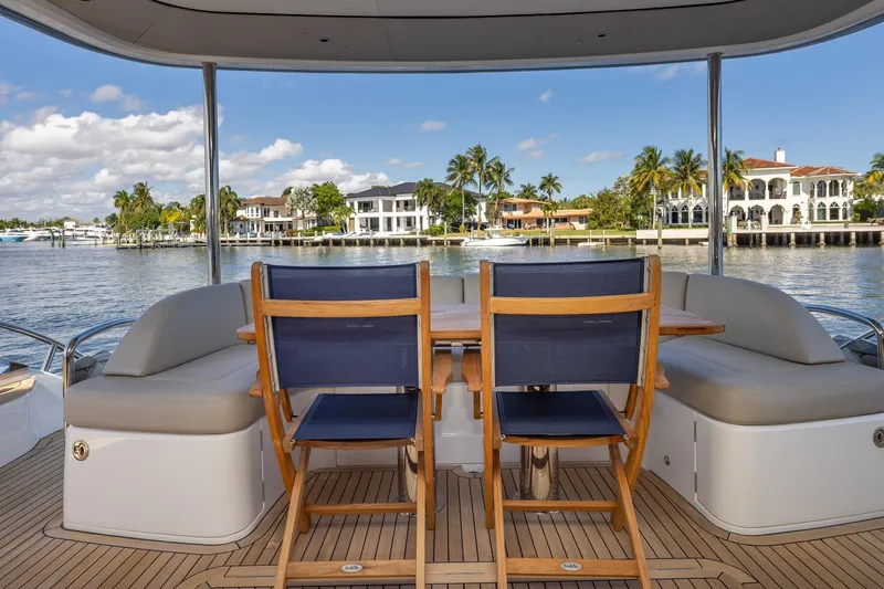 Her Way Yacht Photos Pics Luxury yacht Princess Y72 deck with seating, overlooking waterfront homes and palm trees.