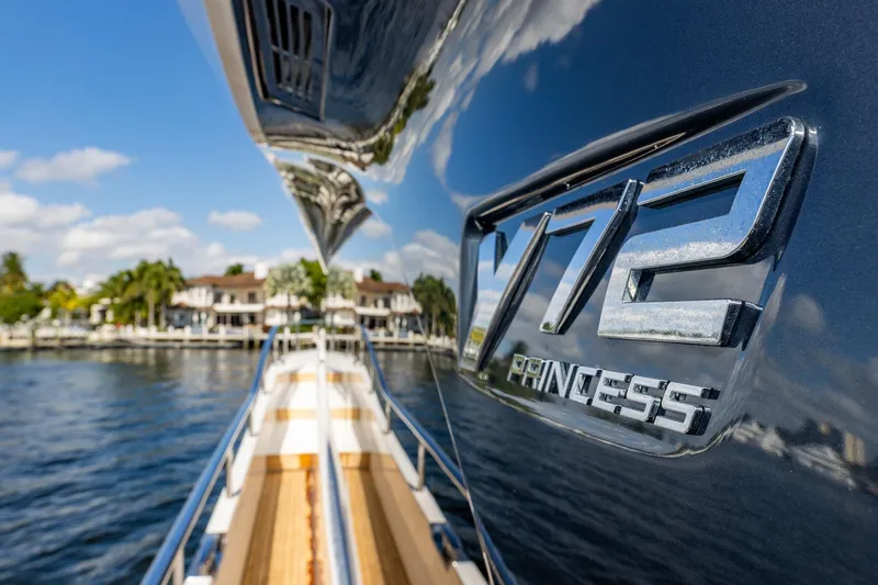 Her Way Yacht Photos Pics 2023 Princess Y72 yacht reflecting water and houses, showcasing luxury design.
