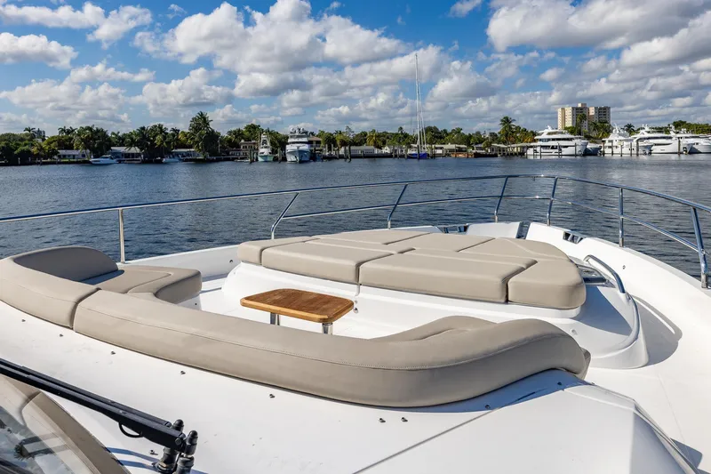 Her Way Yacht Photos Pics Luxurious 2023 Princess Y72 yacht deck with plush seating, overlooking serene waterfront.