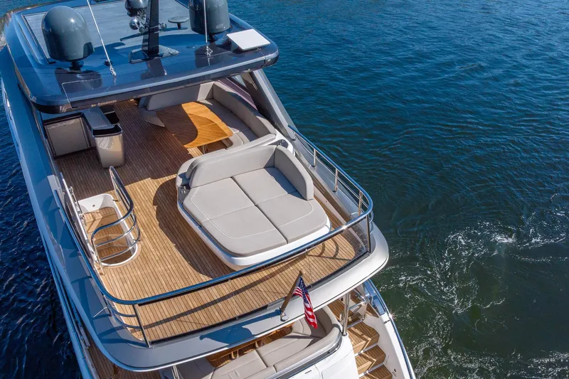Her Way Yacht Photos Pics Luxurious 2023 Princess Y72 yacht with spacious deck and seating area on the water.