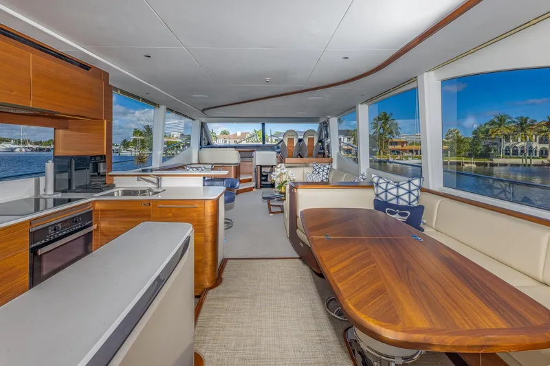 Her Way Yacht Photos Pics Luxurious interior of 2023 Princess Y72 yacht with elegant wood finishes and panoramic windows.
