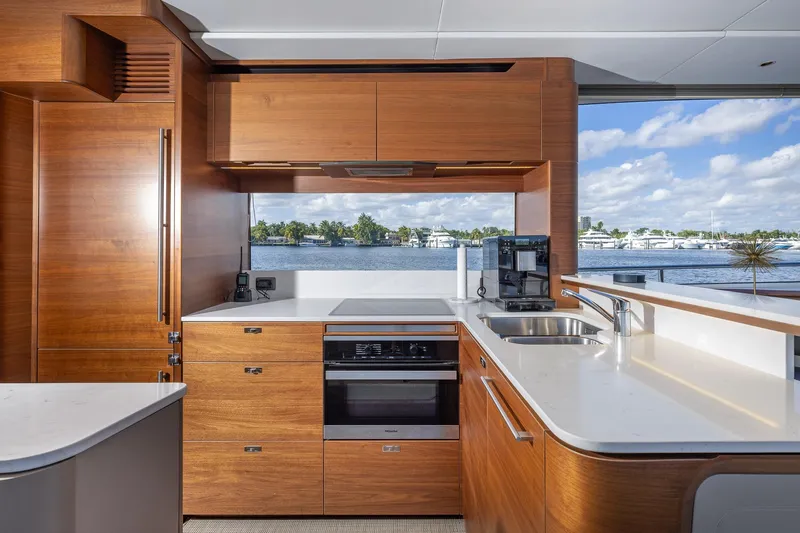 Her Way Yacht Photos Pics Luxurious kitchen interior on 2023 Princess Y72 yacht with modern appliances and scenic water view.