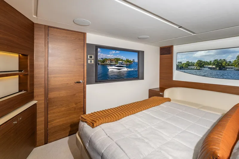 Her Way Yacht Photos Pics Luxurious 2023 Princess Y72 yacht bedroom with elegant wood finishes and scenic window views.