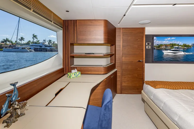Her Way Yacht Photos Pics Luxurious interior of 2023 Princess Y72 yacht with elegant wood finishes and scenic window view.