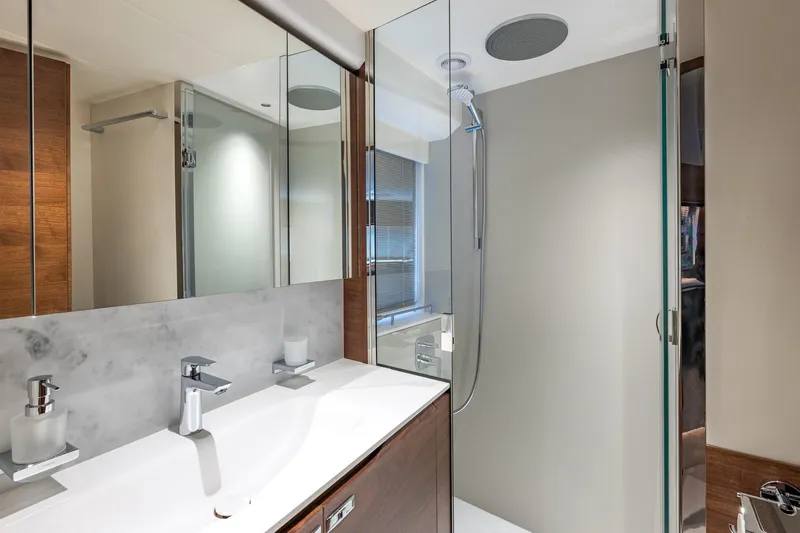Her Way Yacht Photos Pics Luxurious bathroom in 2023 Princess Y72 yacht with modern fixtures and glass shower.