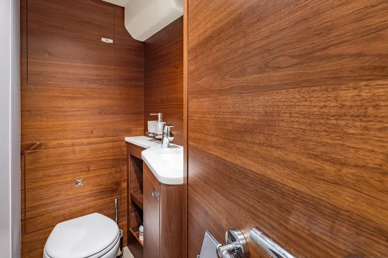 Her Way Yacht Photos Pics Luxurious wooden bathroom interior on 2023 Princess Y72 yacht, featuring modern fixtures.