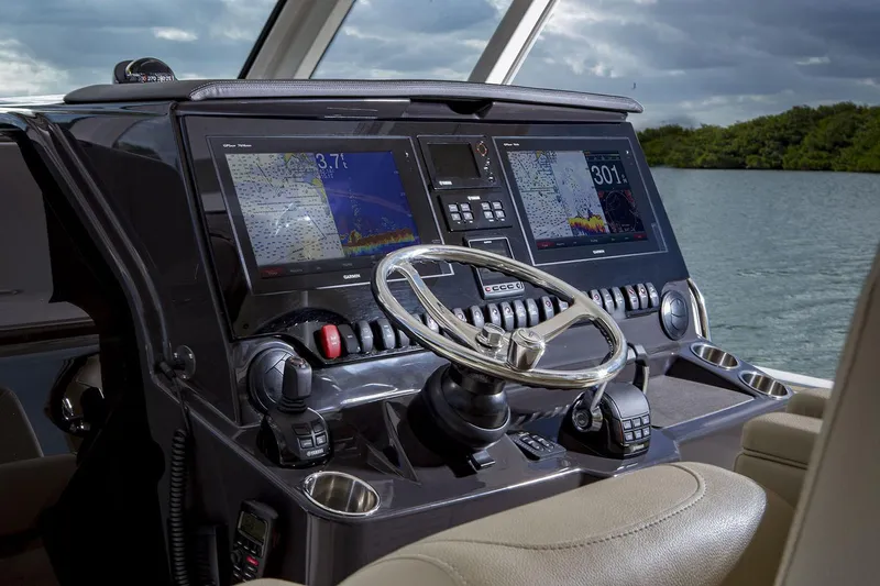  Yacht Photos Pics Manufacturer Provided Image: 2019 Pursuit S 408 Sport boat dashboard with dual navigation screens and steering wheel.