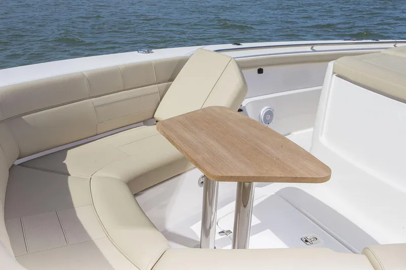  Yacht Photos Pics Manufacturer Provided Image: 2019 Pursuit S 408 Sport boat with beige seating and wooden table.