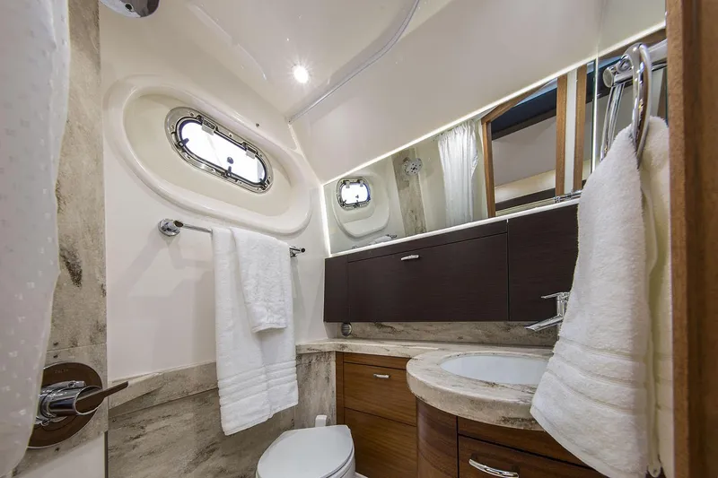  Yacht Photos Pics Manufacturer Provided Image: Luxurious bathroom in 2020 Pursuit S 408 Sport boat with modern fixtures and porthole window.