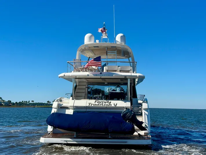  Yacht Photos Pics Luxury yacht Absolute 72 FLY 2016 cruising on open water, rear view.