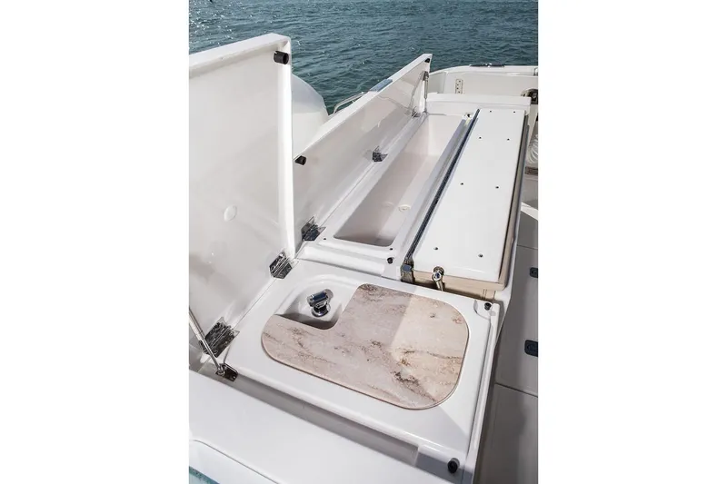  Yacht Photos Pics Manufacturer Provided Image: 2020 Pursuit S 368 Sport boat storage compartments and cutting board.