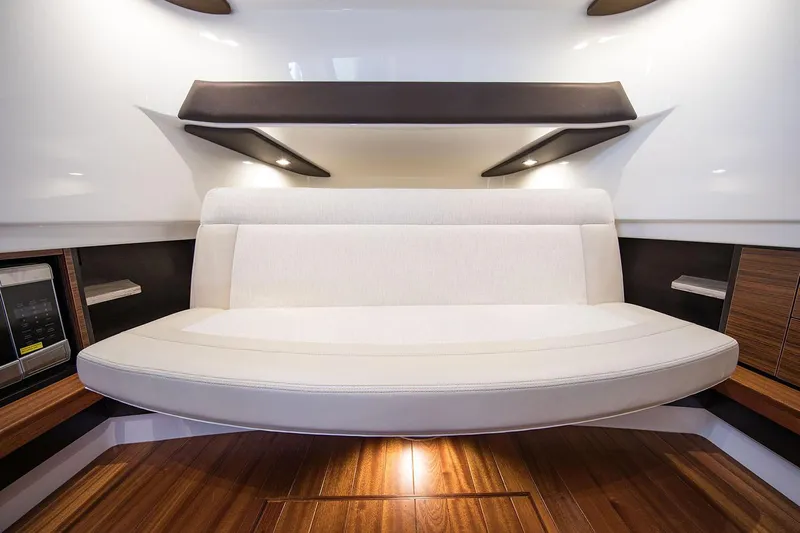  Yacht Photos Pics Manufacturer Provided Image: Interior seating area of 2019 Pursuit S 368 Sport boat with wooden flooring.