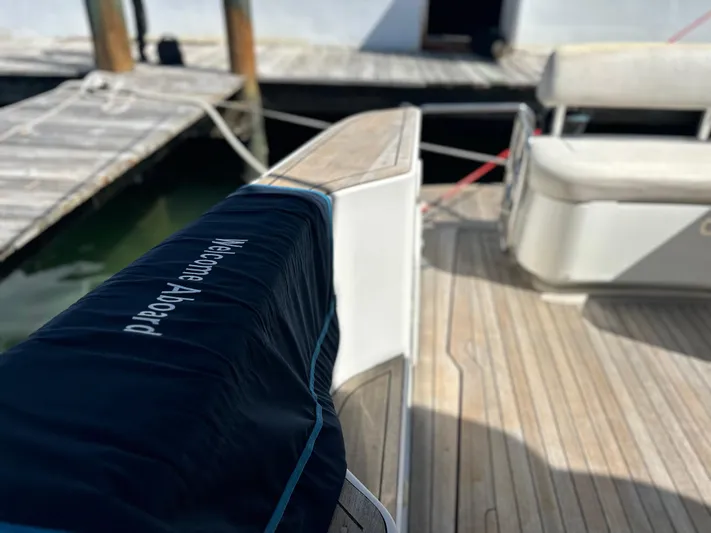  Yacht Photos Pics 2006 Chris-Craft 43 Roamer yacht deck with "Welcome Aboard" cover, docked at marina.