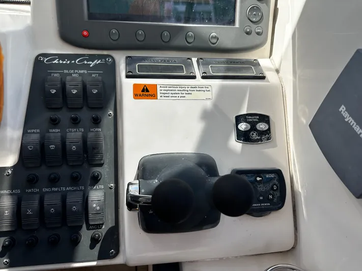  Yacht Photos Pics Control panel of a 2006 Chris-Craft 43 Roamer boat with switches and throttle levers.