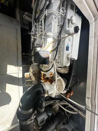  Yacht Photos Pics Engine compartment of a 2006 Chris-Craft 43 Roamer boat, showcasing mechanical components.