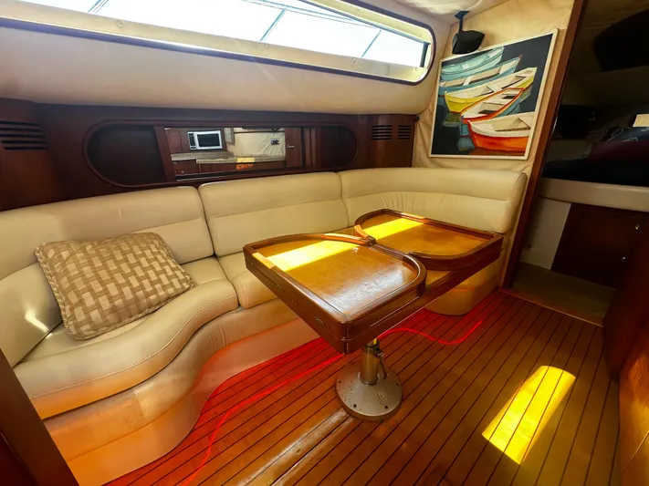  Yacht Photos Pics Luxurious interior of 2006 Chris-Craft 43 Roamer yacht with elegant seating and wooden table.